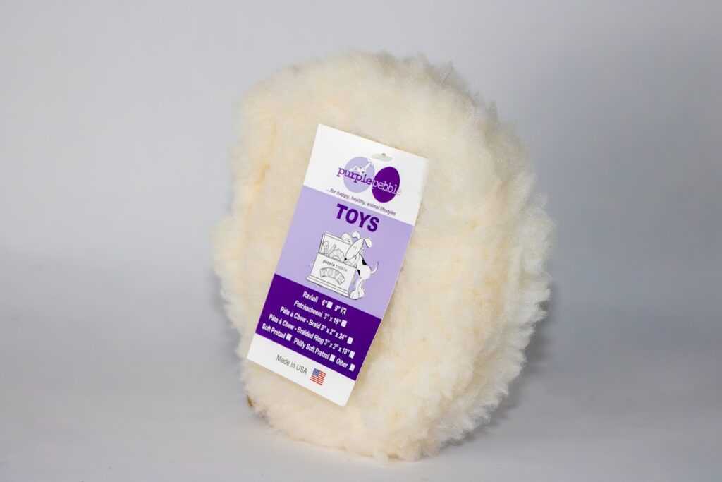 Fluffy toy with a purple label attached.